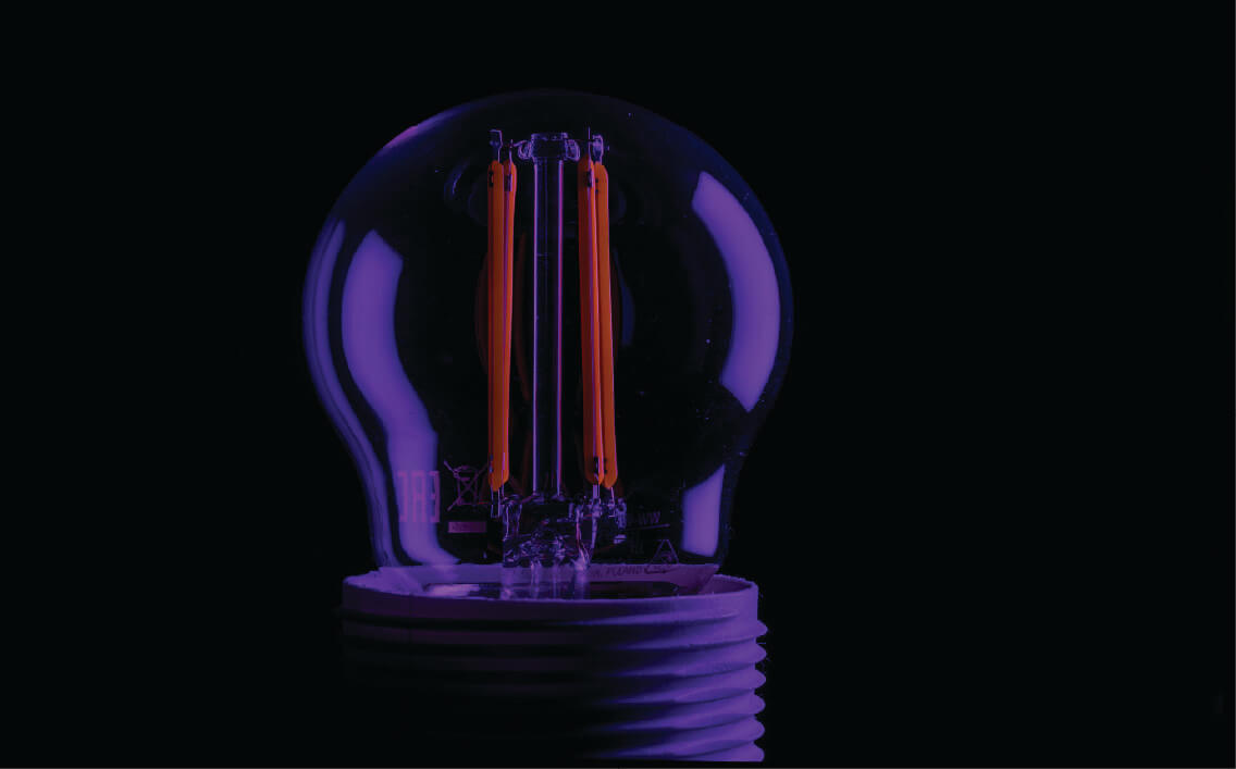 Purple light bulb glowing, symbolizing innovative lighting solutions by Siren Electric